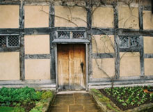 A wooden door set into the wall of an old building.